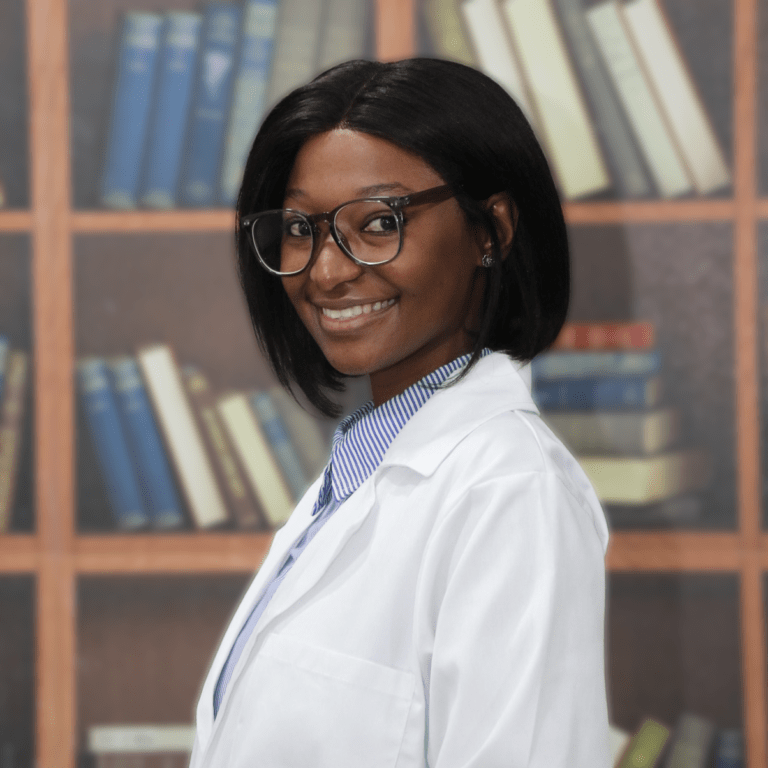 Dr. Ngobeni, a dynamic dentist specializing in pediatric and aesthetic dentistry, smiling confidently in front of a bookshelf at Smile Dental Studio.