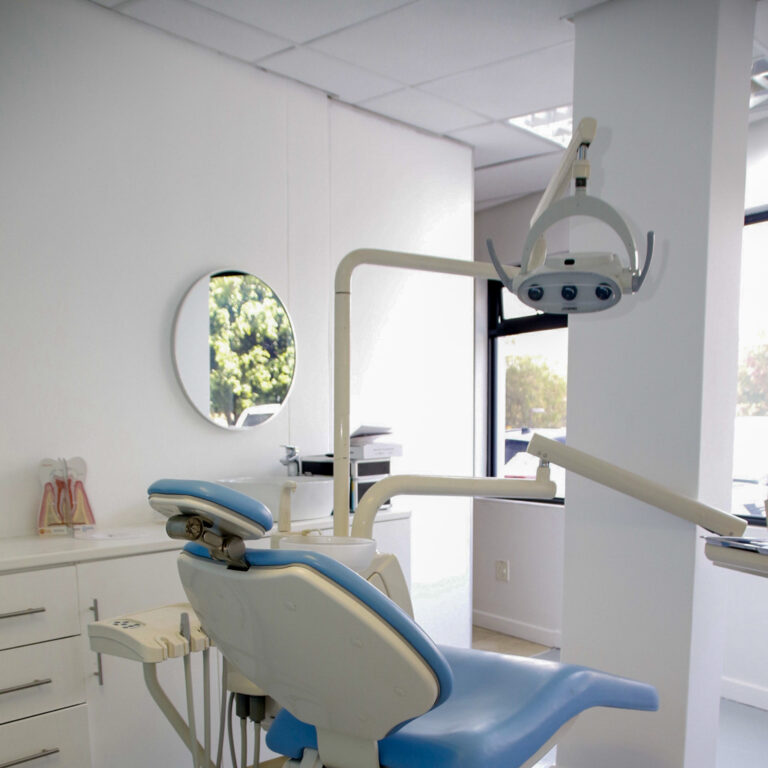 Modern dental clinic with a comfortable dental chair, advanced equipment, and a clean, bright environment.